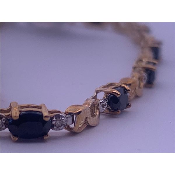 10k yellow gold bracelet with sapphires accented by melee diamonds; weighs 4.64 grams