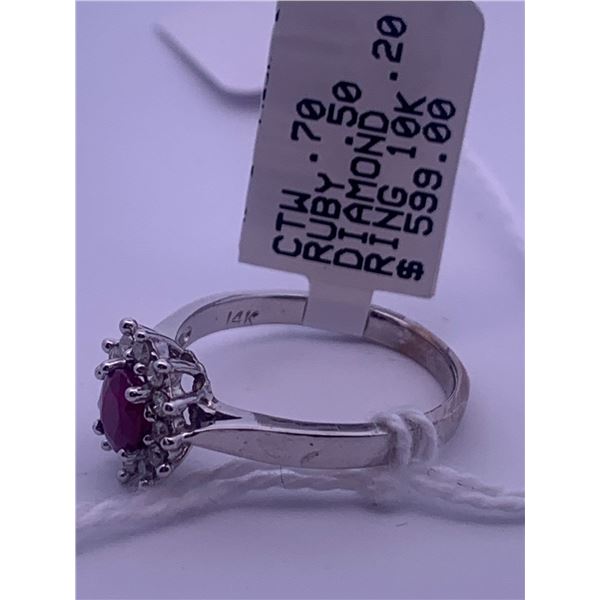 10k white gold ring with a large centre ruby, and melee diamonds surrounding; weighs 2.57 grams