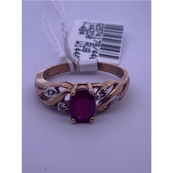 10K yellow gold ring with a ruby centre stone, with melee diamonds; weighs 2.47 grams