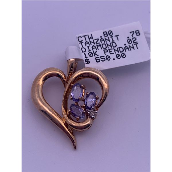 10k yellow gold heart pendant with 3 tanzanite stones, and 1 melee diamond; weighs 3.29 grams