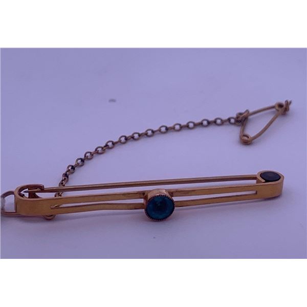 9k yellow gold brooch with blue stone; weighs 1.91 grams
