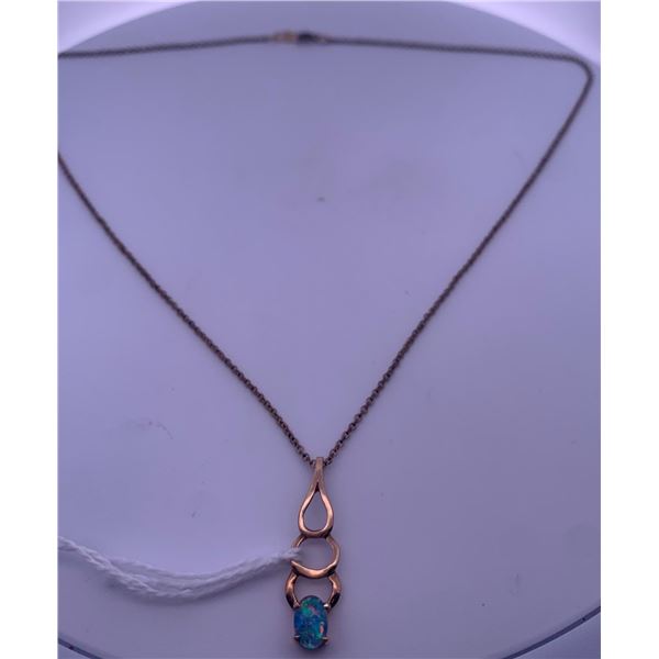 Gold Filled chain (Plated), with a gold colored pendant with blue opal; weighs 2.49 grams