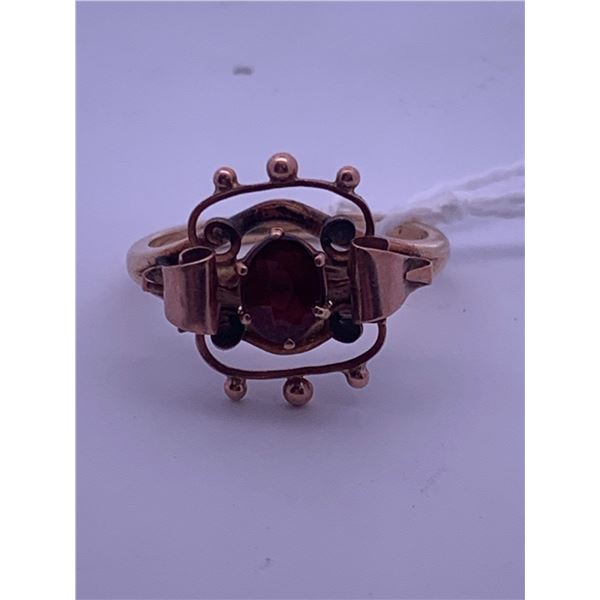10k rose gold ring with a garnet(?) centre stone; weighs 2.93 grams