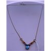 Image 1 : 10k yellow gold necklace with blue topaz, and melee diamonds; weighs 2.43 grams