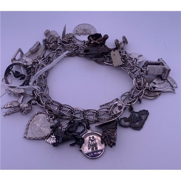 Sterling silver (925) bracelet with many different charms; total weight is 69.57 grams