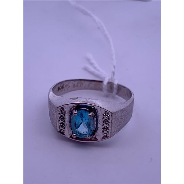 10k white gold ring with a blue topaz(?) centre stone; weighs 3.31 grams