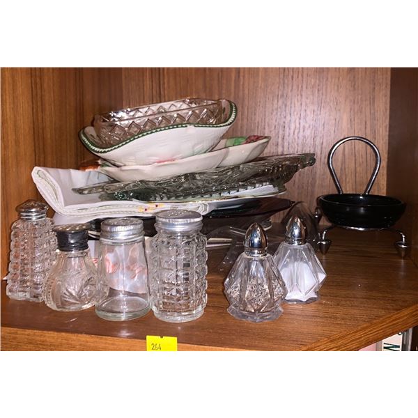 Various kitchen items including salt and pepper shakers, various plates bowls and dishes, etc.