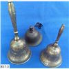 Image 3 : Group of 7 vintage bells, all brass except 1 of them. The bell with the partial leather strap is mar