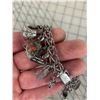 Image 4 : VINTAGE 1970S STERLING SILVER CHARM BRACELET AND MANY STERLING CHARMS