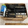 Image 2 : Box of routers, AC-DC adapters and a battery charger.