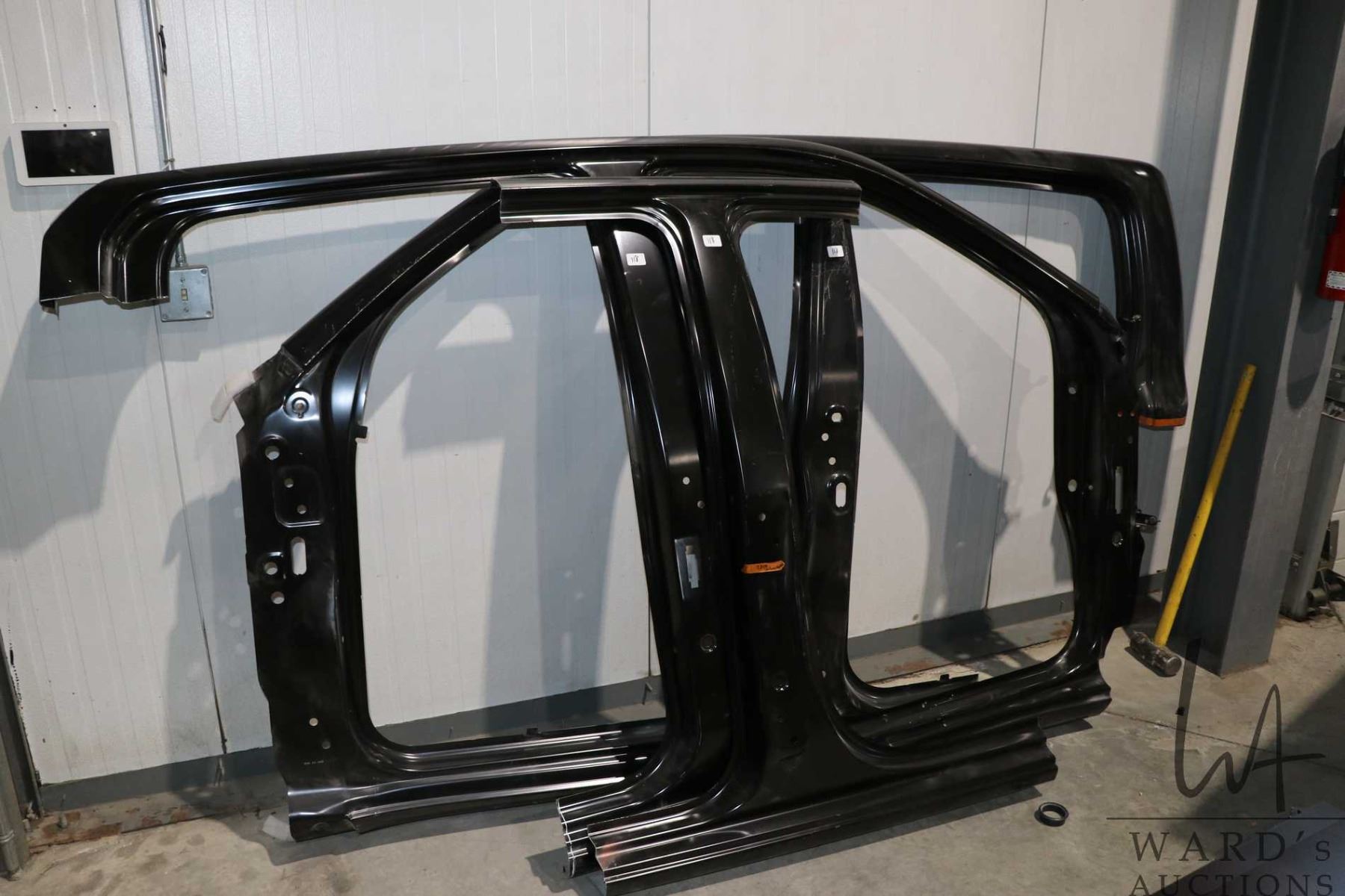Three unidentified body panels, each with one section removed