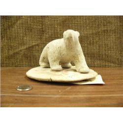 Carved bone bear on whale bone disk (223)