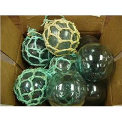 Lot of twelve glass floats, some with netting (2)