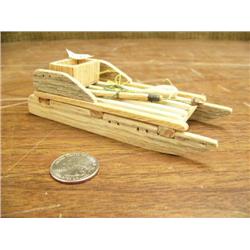 Miniature wooden sled with spear and gaffling hook by Douglas Sheldon Jr. 2000 5" long (3)