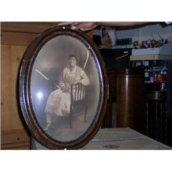 Oval walnut frame bowed glass 23x17