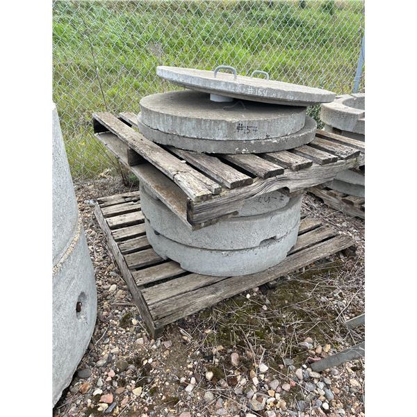 Three Concrete manhole lids and three 24" concete risers