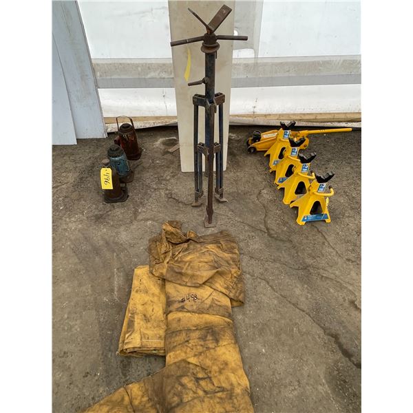 Water tank, pipe stand and roll of canvas