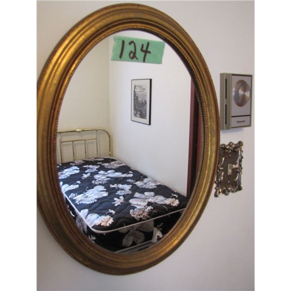 oval wall mirror and 2 framed art work