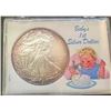 Image 1 : 2010 CHRISTMAS "BABY'S 1ST DOLLAR"- 1 OZ. AMERICAN SILVER EAGLE IN CUSTOM HOLDER