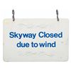 Image 1 : A "Skyway Closed due to wind" Sign.