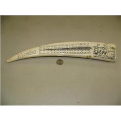 15.5" walrus ivory tusk cribbage board, scrimshawed with man fishing in AK, posts in end (2)