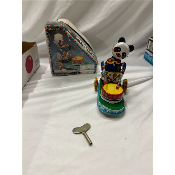 Vintage tin drumming animal with key