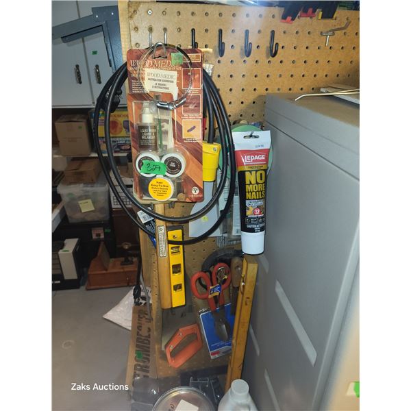 Contents on Pegs Beside the Plastic Storage Cabinet