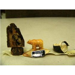 Lot of scrimshawed ivory, ivory bear and seal skin thimble (2)