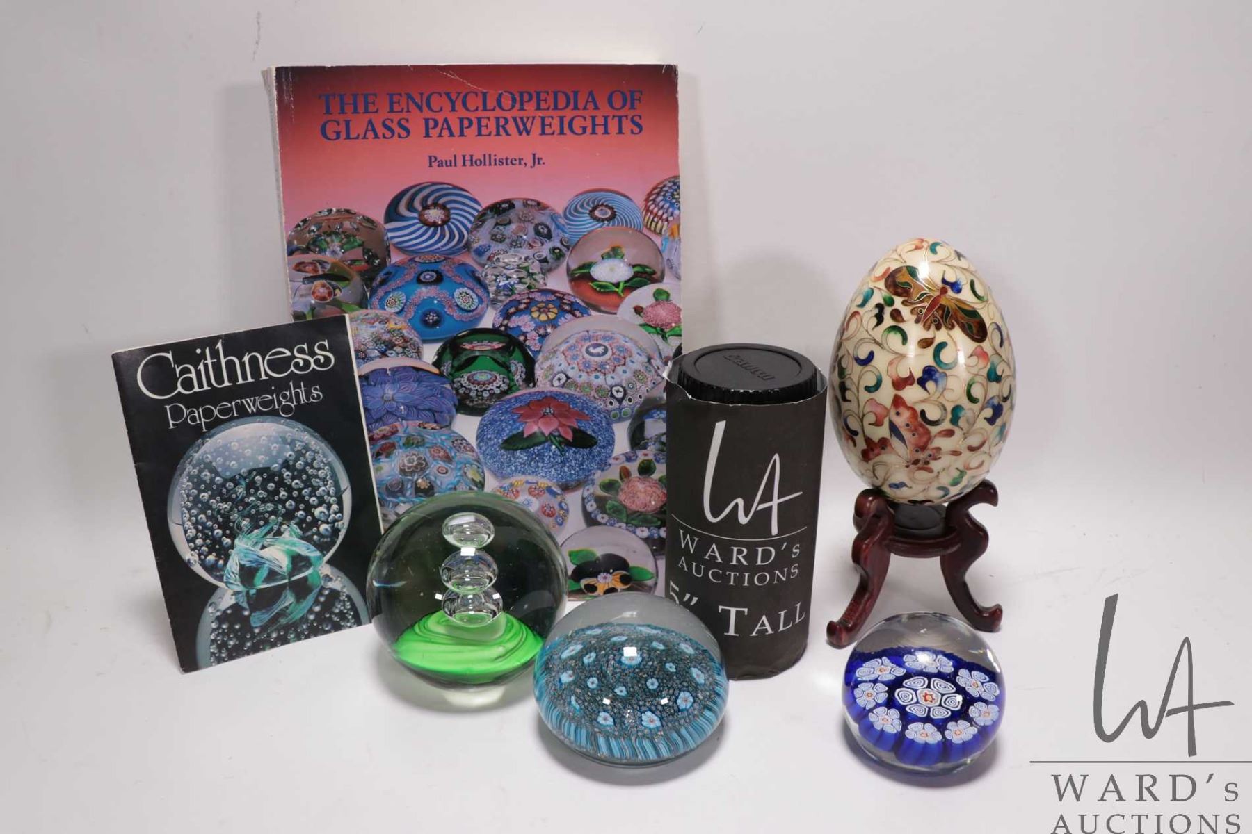 Paperweight Collectables Three collectible glass paperweights, a cloisonne egg on stand and a ...