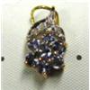 Image 1 : Tanzanite and diamond pendant 14k yellow and white gold: tanzanite (round, faceted, approx. .5 carat