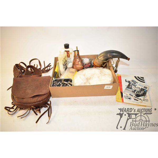 Selection of black powder accessories including horn flask, copper flask, leather carrying case, nip