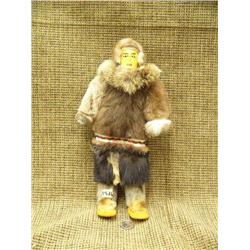 CHOICE On 2 leather faced dolls: green and red trim on parka and glass bead eyes (74)