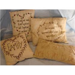 Four embroidered pillows