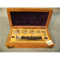 Set of brass weights in wooden box (3)