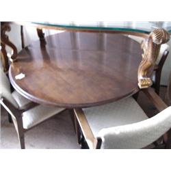 Round walnut table and three arms chairs (241)