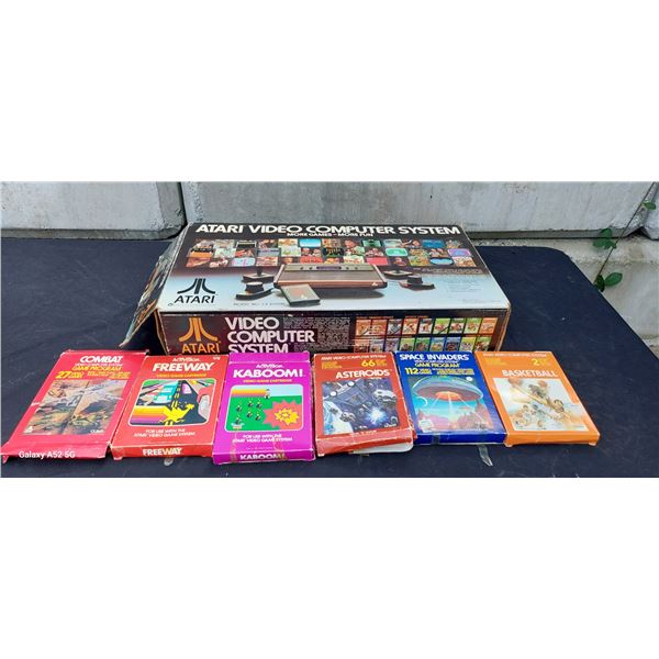 Vintage in box Atari 2600 console with various boxed games