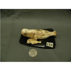 Pr. Of fossilized ivory seals - mother is 4.25, baby is 1.5 by Robert Apatiki, largest ones by this 