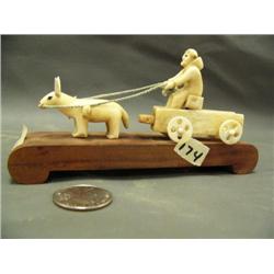 Walrus ivory, Eskimo made, man in wagon being pulled by a animal, very important, early, rare carvin