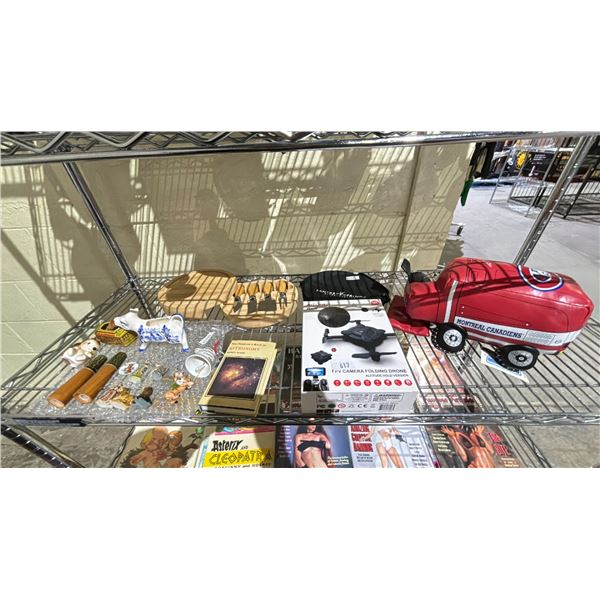 SHELF OF ASSORTED ITEMS INCLUDING; FPV CAMERA FOLDING DRONE, FIGURINES, CHARCUTERIE KNIFE SET &