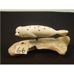 3.5" spotted ivory seal with inset baleen mounted on a jawbone from a baby walrus, Aningayou from Sa