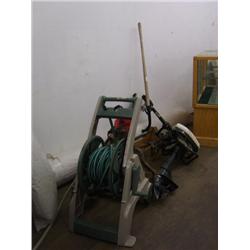 Hose with reel, old outboard motor, weed whacker, shovel, tow bar, set of box end wrenches, vice and
