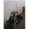 Image 1 : Hose with reel, old outboard motor, weed whacker, shovel, tow bar, set of box end wrenches, vice and