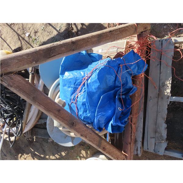 vacuum hose , 4x4 triangular wooden item , tarp , shovel , satellite dishes