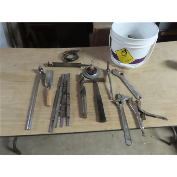 pail of crescent wrenches , pliers , socket storage