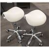 Image 1 : 2 FLOOR MODEL WHITE SADDLE SEAT ROLLING CHAIRS