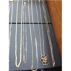Lot of 5 gold chains, one has small gold bands on it (266)