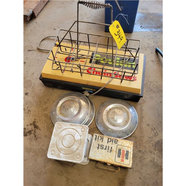 Poulan chainsaw sign, old first aid kit, 24 lb weigh scale & hub caps