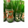 Image 2 : 12 assorted vintage 7-up glass bottles - some with bottling location & 7-up women motif