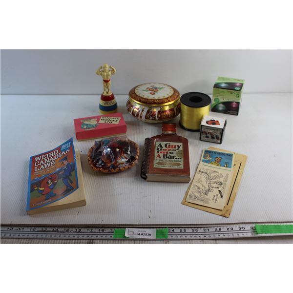 Weird Canadian Laws Book, Bodybuilder Statue, Candy Tin, Rechargeable Electric Pump and Assorted Ite