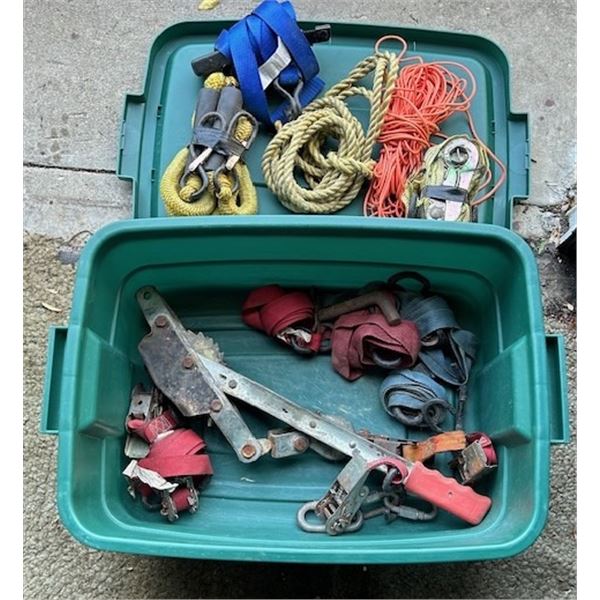 Plastic storage tub containing various tow straps and come-alongs